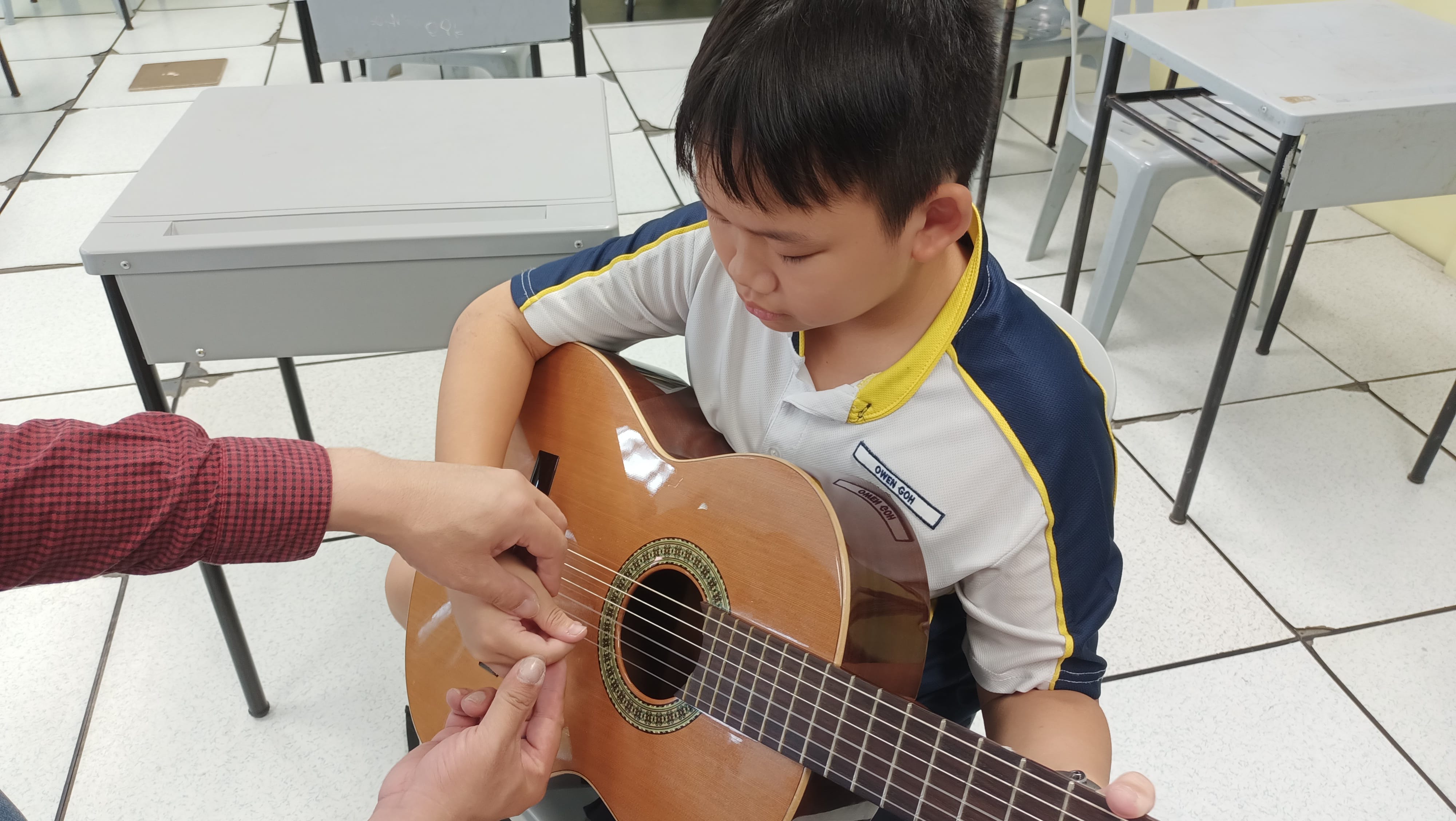 Mr. Daniel Lim helping a member refine his finger positioning